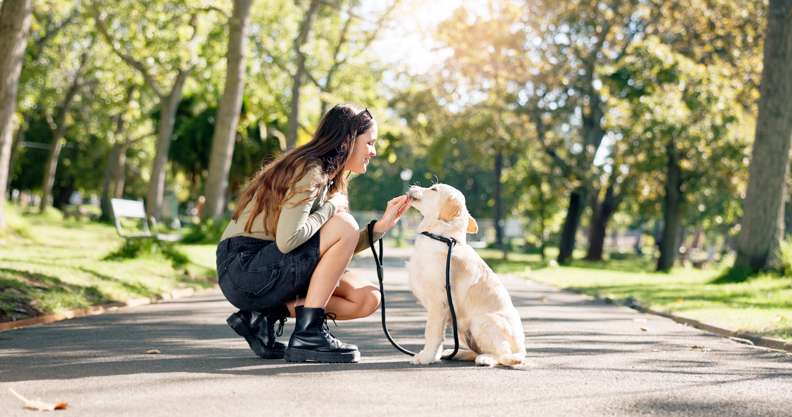 Happy woman with dog in park