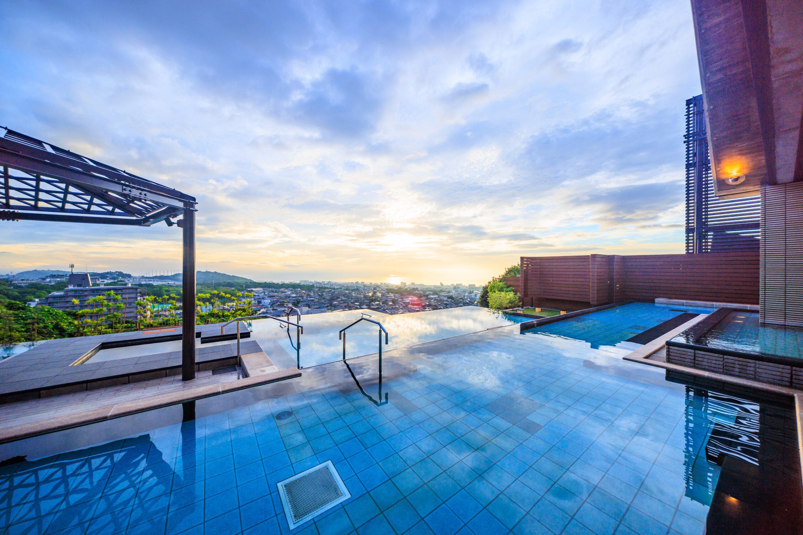 Terraced 'Tanayu' open-air bath overlooking Beppu Bay in the morning
